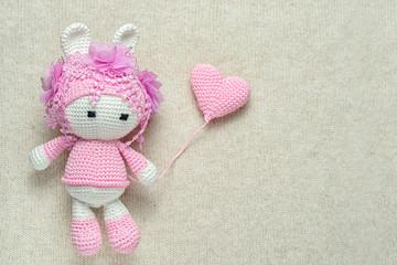 St Valentines card with handmade crochet amigurumi bunny toy with heart shape balloon and plenty of copy space for your inscription