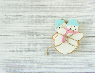 Ginger snowman cookies on wood background. Christmas background, flat lay, top view. Xmas theme