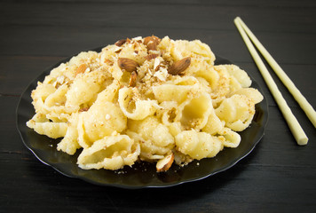 Sweet pasta with nuts and almonds on a plate