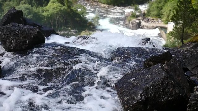 Waterfall at mountain river in summer