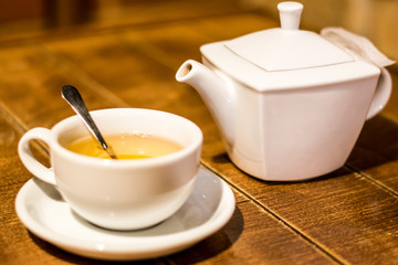 white teapot with a white cup