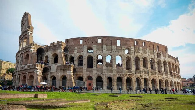 Time lapse of Colosseum, also known as the Flavian Amphitheatre,  with moving cloud and people