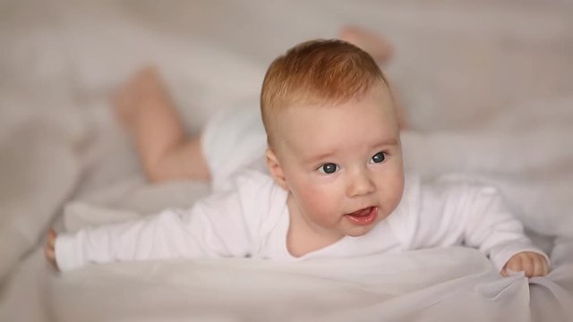 Portrait of four month old baby lying on his stomach