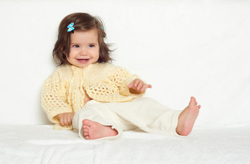 Fototapeta premium happy little child girl sit on white towel, happy emotion and face expression