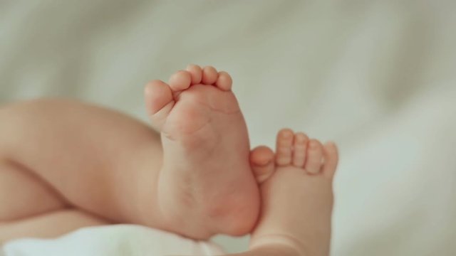 Newborn baby feet isolated on white