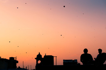 Silhouette of people flying kites 