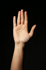 Male hand on a black background