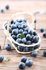Ripe and tasty blueberries on brown wooden table