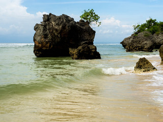 Padang–Padang Beach is one of famous surf point in Bali with the great waves and white sandy. The beautiful beach has white stone hill with nature scenery to the Indian Ocean. 