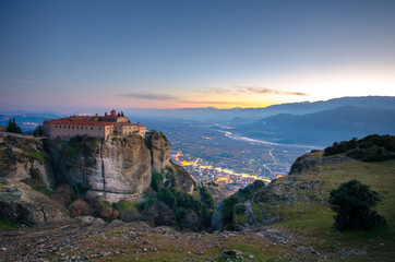 Fototapeta na wymiar Breathtaking view of Meteora Agiou Stefanou Monastery at sunset, Greece. Geological formations of big rocks with Monasteries on top of them.