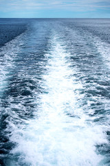 Water trail of cruise ship in open sea.