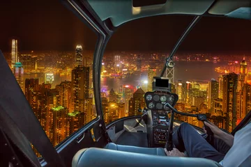 Fotobehang Aerial view inside helicopter cockpit night flight on Hong Kong cityscape in the night in Wan Chai district, Hong Kong island. Concept of transport, travel and business. © bennymarty