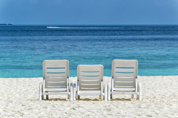 Fototapeta na wymiar Three beach chairs