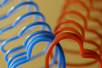 Closeup of two heart-shaped slinky toys intertwined, love concep