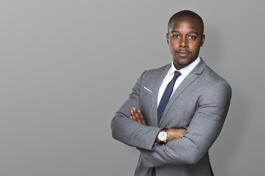 Successful confident black business man isolated with arms folded looking strong