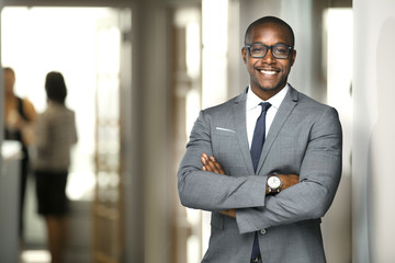 Handsome cheerful african american executive business man at the workspace office  - Powered by Adobe