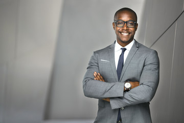 Cheerful financial executive business man stock investor standing tall and proud