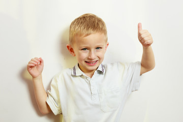 Little boy playing showing thumb up gesture