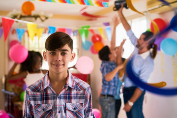 Portrait Of Happy Hispanic Child Smiling At Birthday Party