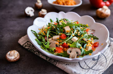 Vegetable salad with arugula, red lentils, mushrooms and smoked Tofu cheese