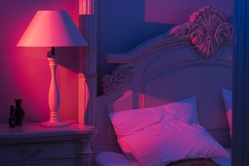 Luxurious minimalistic art décor Bedroom with royal bed, pink and blue light with stylish night...