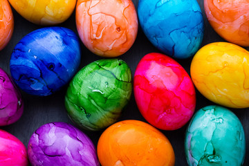 Easter eggs painted in colors on a pattern background.