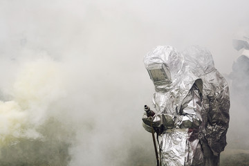 people  in suit of protection against fire