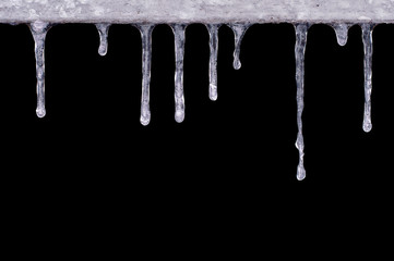 frozen icicles, drops, isolated on a black background