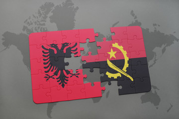 puzzle with the national flag of albania and angola on a world map