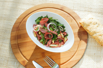 salad in white bowl on a background of nature