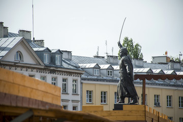 warsaw city in poland house background Statue in front that pays tribute to Jan Kilinski © CL-Medien