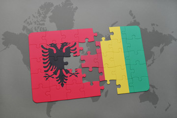 puzzle with the national flag of albania and guinea on a world map