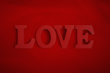 Wooden letters spelling LOVE on a red background