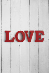 Wooden letters spelling LOVE on a wood background