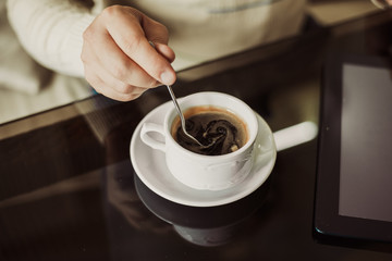 Young successful man sitting in a cafe with  cup of coffee