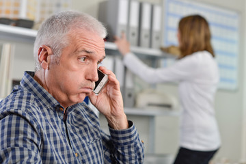 Man on telephone, exasperated expression