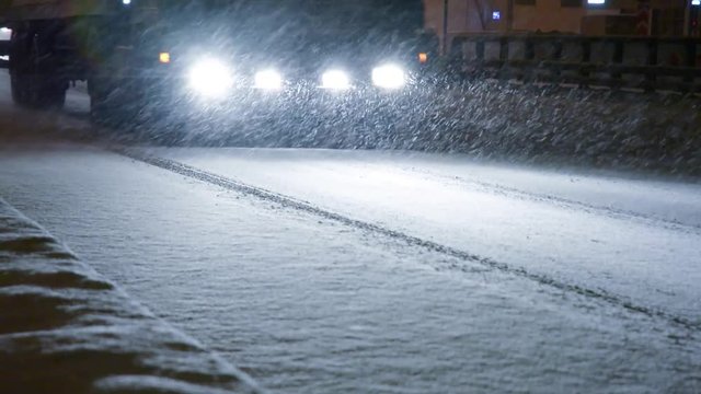 Cars on the city road in a snowstorm.