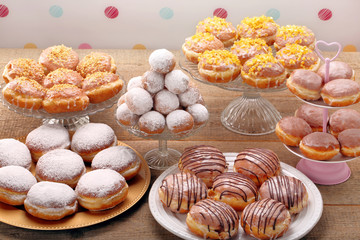 Different types of donuts cakes on wooden table