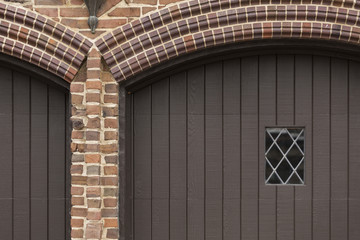 Garage with Diamond Paned Window and Brick Arch