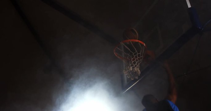 Sportsman dunking basketball in hoop at basketball court 4k