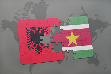 puzzle with the national flag of albania and suriname on a world map
