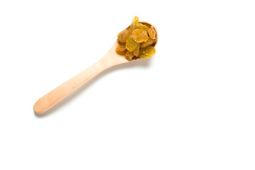 A driend raisin in a wooden spoon isolated over white background