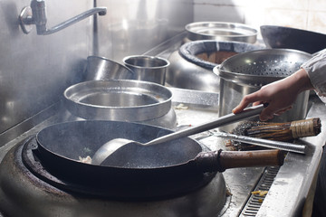 Close up of working chef preparing chinese food