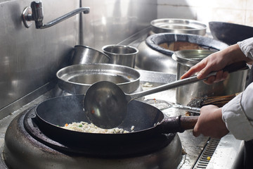 Close up of working chef preparing chinese food