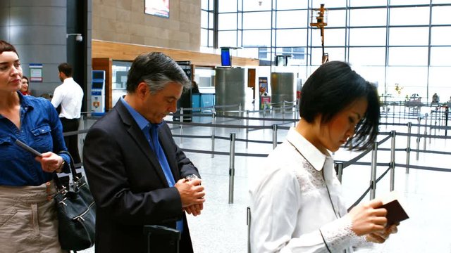Commuters standing in queue for check-in at airport