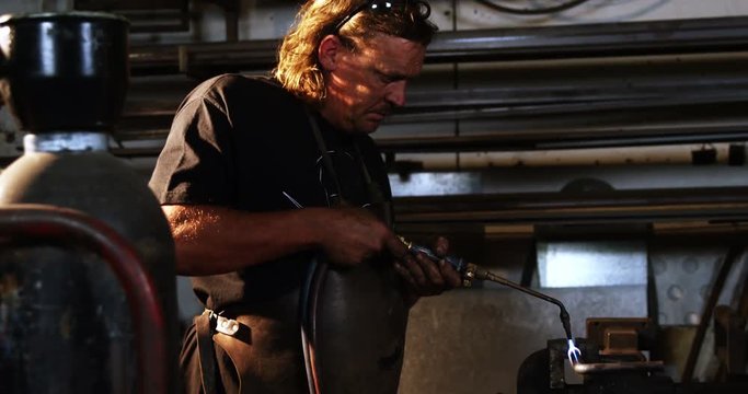 Welder using welding torch in workshop 4k