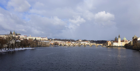 Fototapeta premium Snowy freeze Prague Lesser Town with gothic Castle and Charles Bridge, Czech republic