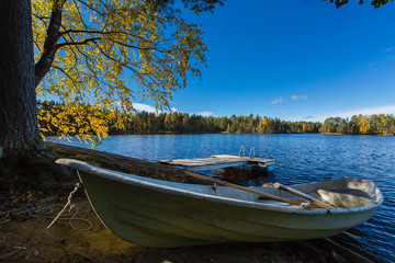 Naklejka na ściany i meble Boat at the bank of the lake at Suomi.