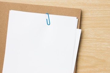Open blank white paper notebook with copyspace and a pen lying on a white desk, view from above / for your text or message / top view