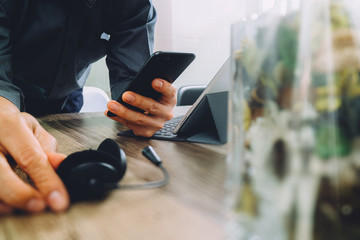 man hand using VOIP headset with digital tablet computer docking